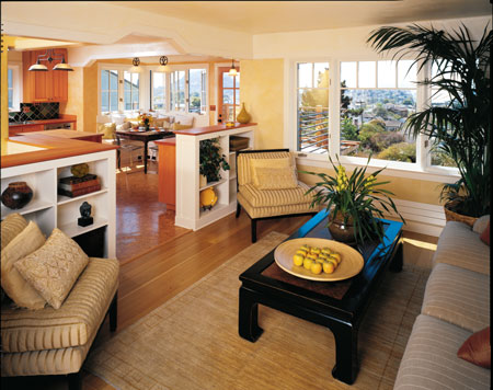 The kitchen, which was closed off behind a wall, is now open to the living room. Low built-in bookshelves and lowered beams define the space while letting air, light, and conversation flow. Beyond, the eating-nook addition also opens the formerly dark kitchen to light and expansive views. The kitchen’s prefinished cork-tile flooring blends well with the refinished white oak floor in the living room.